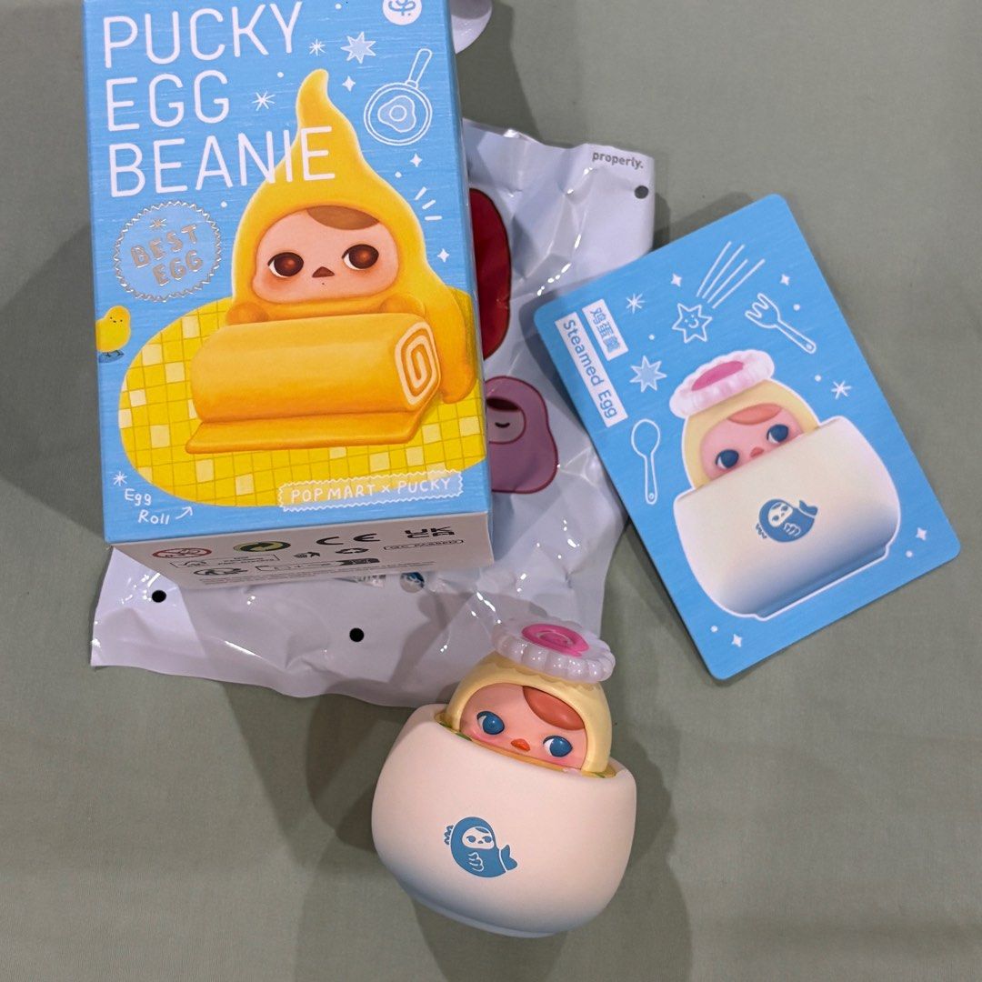 Pucky Egg Beanie Steamed Egg Mini Figurine (Category: Designer & Blind Box Toys) located in Antipolo. Submitted by de.klutter (Listing ID 1392422576, Image 1). Description: POPMART Pucky Egg Beanie Series Blindbox: Steamed Egg Mini Figure CONDITION: Brand new! Just bought recently from Fully Booked. Still comes with its original box, foil & card packaging Open to swap/trade with: Pucky Egg Tart, Nyota Poem, Nyota Feeling, Nyota Hidden in Autumn P