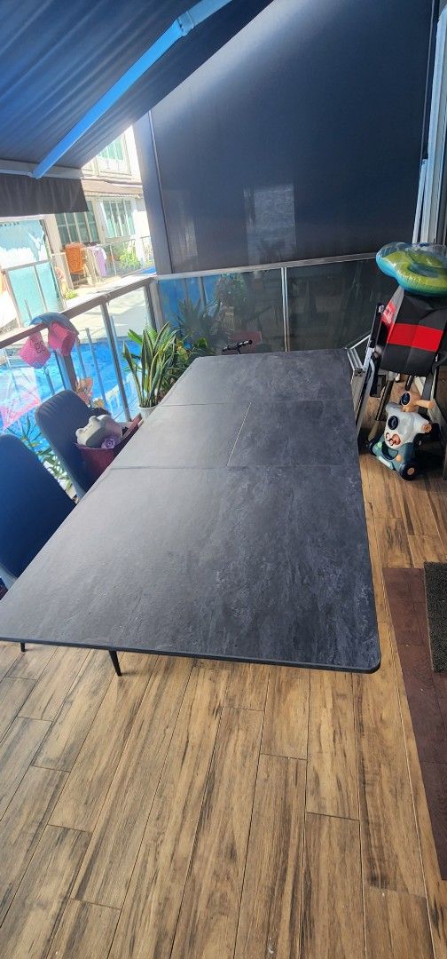Extendable Dining Table (Category: Tables & Sets) located in Singapore. Submitted by seantanls (Listing ID 1392507782, Image 2). Description: - Stylish black dining table - Modern, contemporary design - Unique X-shaped base for stability - Durable tabletop - Ideal for family meals and entertaining guests -pull out to seat even more guest. -table is a bit of warped on a few edges due to moisture. -arrange your own delivery.