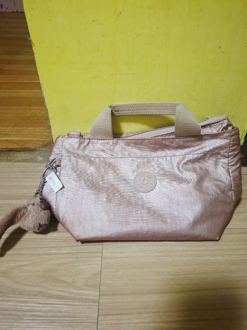 Kipling Cross body bag (Category: Luxury Bags & Wallets) located in Manila. Submitted by whut_gurl_ (Listing ID 1392627996, Image 1). Description: Selling this authentic Kipling Art Mini bag. It's a versatile handbag that can be carried by its top handles or worn as a crossbody with the detachable shoulder strap (included but not shown). The color is a stunning metallic rose gold that adds a stylish touch to any outfit. This bag has only been use
