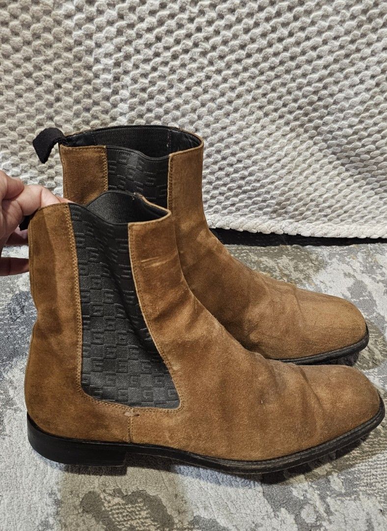 Men's Gucci Chelsea Boots (Category: Boots) located in Quezon City. Submitted by ricac. (Listing ID 1392572518, Image 2). Description: Step up your style with these authentic Gucci Chelsea Boots, crafted in rich brown suede with black elastic side panels featuring the subtle GG logo weave. Made in Italy, these boots embody Gucci’s signature blend of luxury and timeless design..