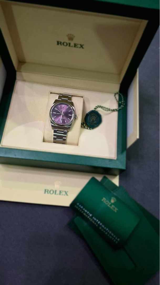 Rolex Oyster Perpetual 34 (Category: Luxury Watches) located in Angeles City. Submitted by tatasexy_24 (Listing ID 1392631776, Image 2). Description: Rolex Oyster Perpetual 34 (Ref. 114200) Color: Grape (Violet) Discontinued and increasingly rare. Single-owner piece, originally purchased in 2020 from an Authorized Dealer. In excellent condition with only minor hairline scratches on the bracelet. Offered as a complete set with original box and pap