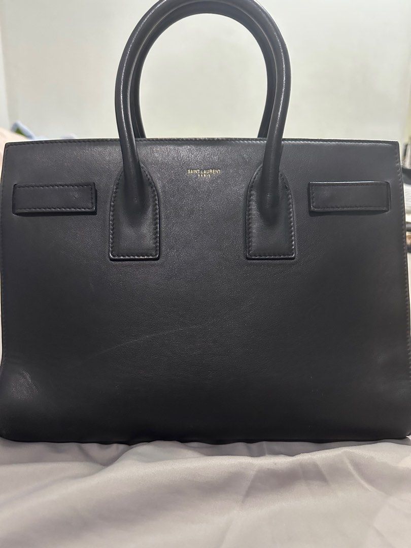 YSL Saint Laurent Sac De jour Small (Category: Luxury Bags & Wallets) located in Makati City. Submitted by rnathaliem (Listing ID 1392540411, Image 3). Description: YSL Saint Laurent Sac De jour Small 30 width 24 length Accordion style Black No strap (but i can include generic strap with gold hardware).