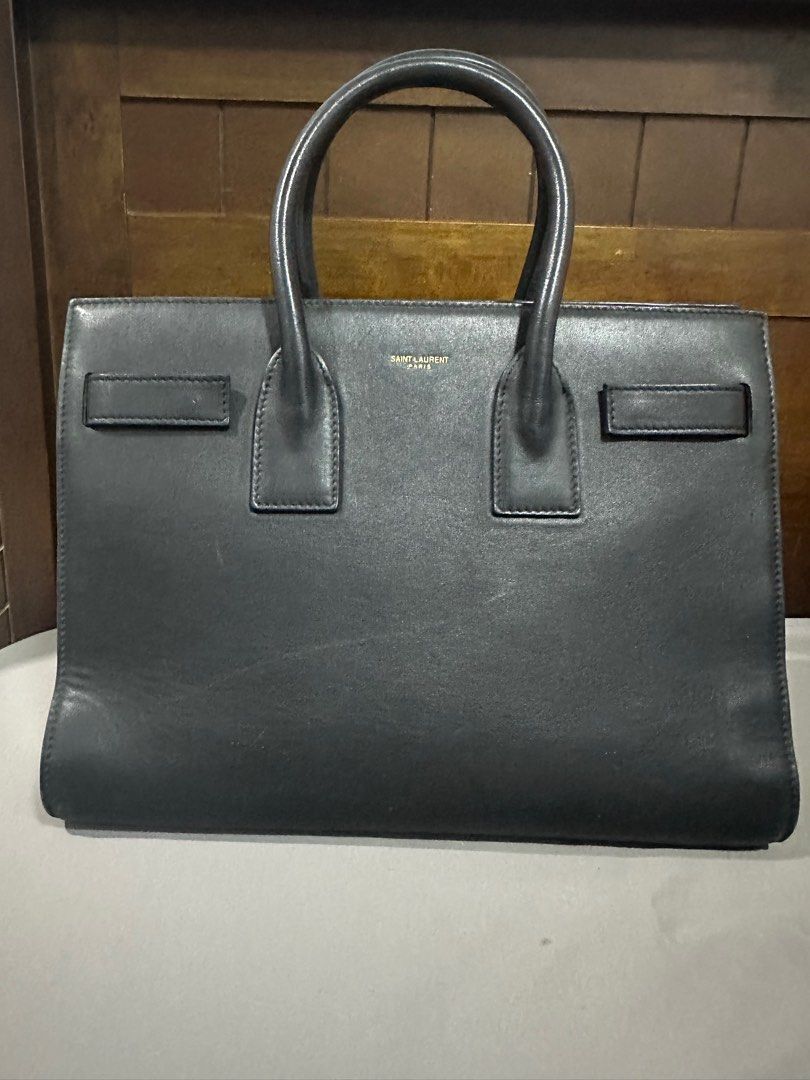 YSL Saint Laurent Sac De jour Small (Category: Luxury Bags & Wallets) located in Makati City. Submitted by rnathaliem (Listing ID 1392540411, Image 2). Description: YSL Saint Laurent Sac De jour Small 30 width 24 length Accordion style Black No strap (but i can include generic strap with gold hardware).