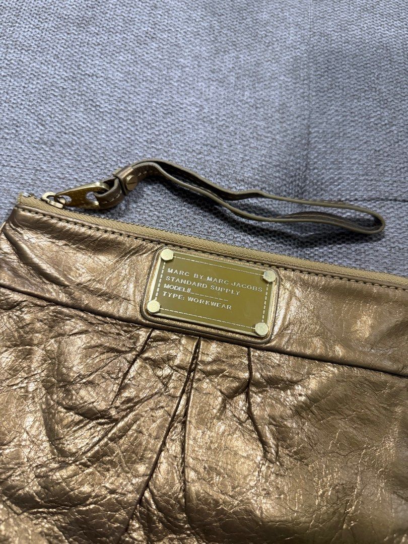 Marc Jacobs Genuine Leather Wristlet (Category: Luxury Bags & Wallets) located in Bacolod City. Submitted by charmvault (Listing ID 1392715121, Image 2). Description: 📌Marc Jacobs Wristlet •US Bought🇺🇸 •Orig💯 •Genuine Metallic Leather •Preloved item | In excellent condition •No issues | Very durable •Fits iphone pro max, small items etc. •What you see is what you get •Pass sa barat!!! •No COD | COP | Payment 1st Policy •SF c/o Buyer via J&T E