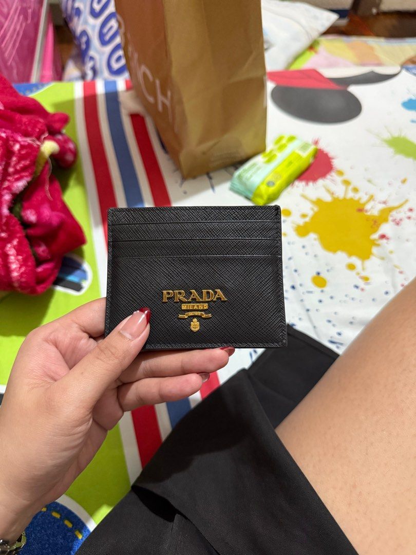 PRADA CARD HOLDER (Category: Luxury Bags & Wallets) located in Manila. Submitted by caiaguila (Listing ID 1392824133, Image 1). Description: • like new • with complete box and dust bag (nakahiwalay photos since nasa kabilang house yung card holder, not sabay ko napicture) • personal used • low ballers will not be entertained.