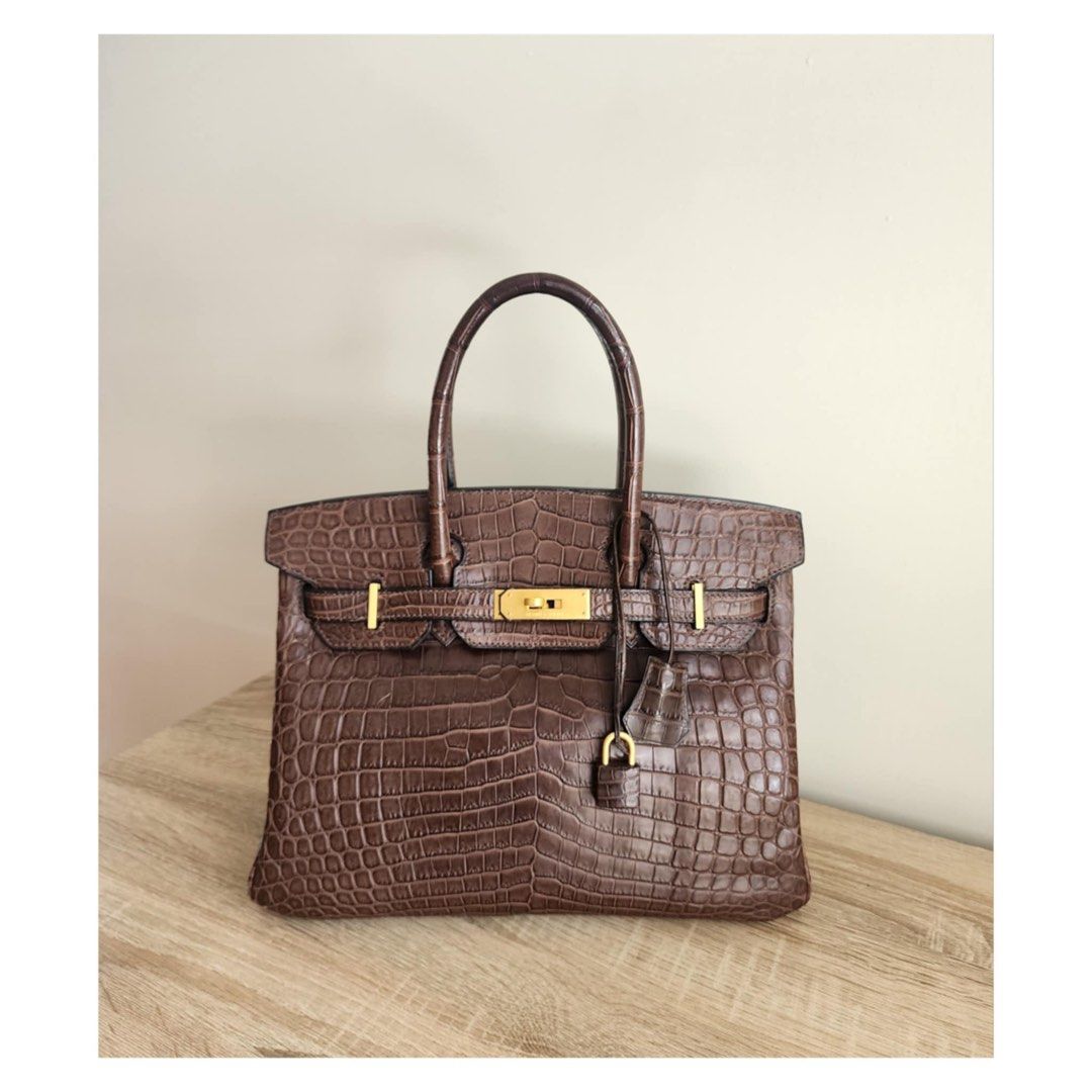 Hermes Birkin 30 Croc Havana (Category: Luxury Bags & Wallets) located in Manila. Submitted by luxe88nhelmueller (Listing ID 1392924212, Image 1). Description: Available on hand Pre owned In good condition 🔥 Hermes 🔥 Birkin 30 Havane Matte Niloticus Crocodile Matte Gold Hardware Toile Canvas Interior Stamp G Year 2003 Comes with Clochette, Lock, keys, Dustbag, Raincoat And box.