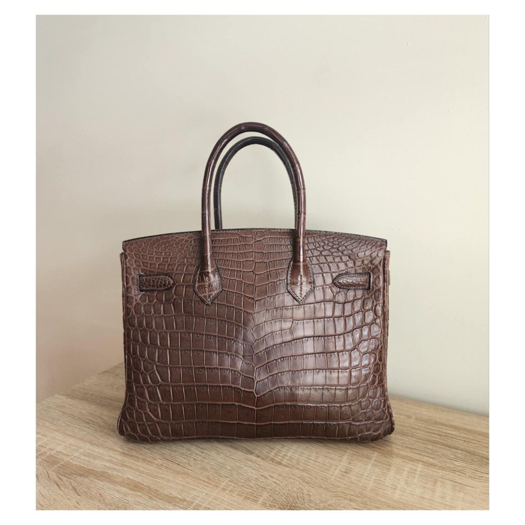 Hermes Birkin 30 Croc Havana (Category: Luxury Bags & Wallets) located in Manila. Submitted by luxe88nhelmueller (Listing ID 1392924212, Image 2). Description: Available on hand Pre owned In good condition 🔥 Hermes 🔥 Birkin 30 Havane Matte Niloticus Crocodile Matte Gold Hardware Toile Canvas Interior Stamp G Year 2003 Comes with Clochette, Lock, keys, Dustbag, Raincoat And box.