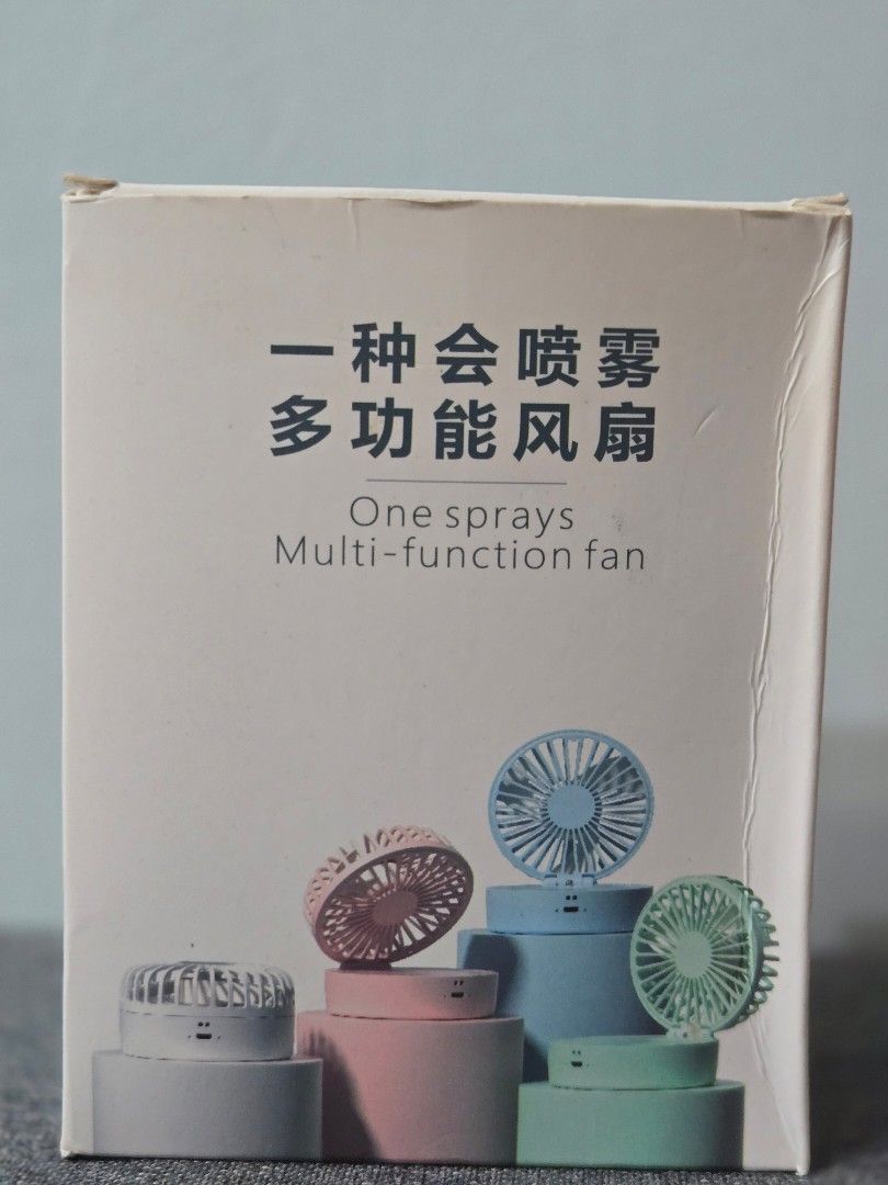 Multi-function Spray Fan (Category: Fans) located in Singapore. Submitted by koabear (Listing ID 1392990809, Image 1). Description: - New multi-function spray fan - 3-speed settings - USB rechargeable - Built-in 18650 lithium battery - Water spray function for extra cooling - Includes small refill bottle.