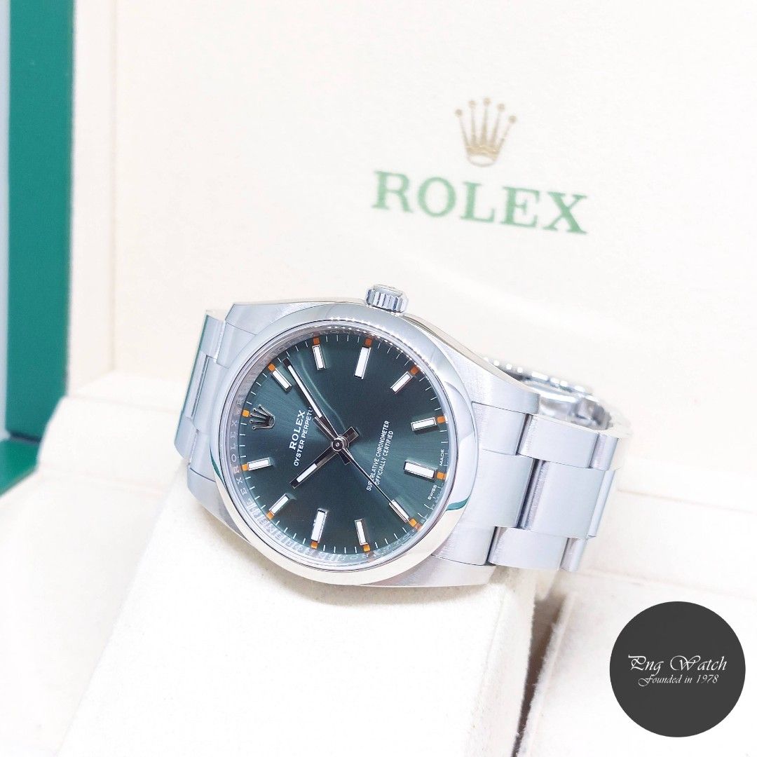 Rolex 34mm Olive Green Dial Oyster Perpetual REF: 114200 (Feb 2019) (Category: Watches) located in Singapore. Submitted by pngwatchdealer (Listing ID 1393048791, Image 2). Description: [SPECIFICATIONS] **Watch comes in full option (Box & Card)** **Straight bracelet** Brand: Rolex Model: Oyster Perpetual (REF: 114200)(AN)(02/19)(O) Movement: Automatic (Self-Winding) Functions and Features: Hours, Minutes and Seconds (CASE) Case Material: Stainless
