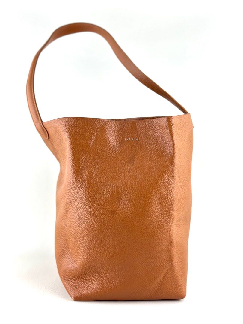 THE ROW N/S Park Tote (Category: Luxury Bags & Wallets) located in Manila. Submitted by luvluxe.mnl (Listing ID 1393054405, Image 1). Description: Authentic Medium size With minimal rubs on the lower corner but is unnoticeable when worn— over all in very good condition!! No functionality issue Rare color way.