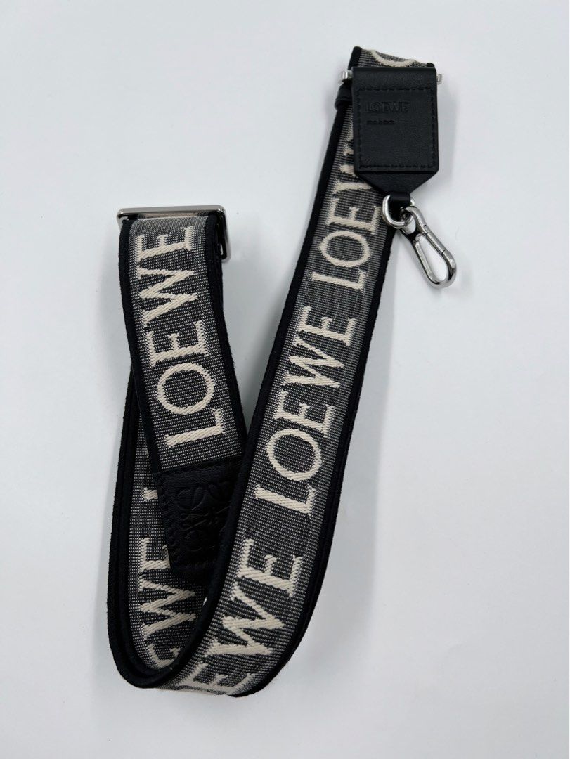 ⚜️Loewe Reversible Strap (Category: Luxury Accessories) located in Makati City. Submitted by 90sangel (Listing ID 1308214442, Image 2). Description: •Item: Loewe - White Anagram-jacquard Reversible Shoulder Strap 🖤 •Size: One size •Condition: Excellent! 💯 *W/ Adjustable fit carabiner attachments. This piece comes complete with a protective dust bag / paperbag. Material:calfskin/Fabric. 🖤🤍.
