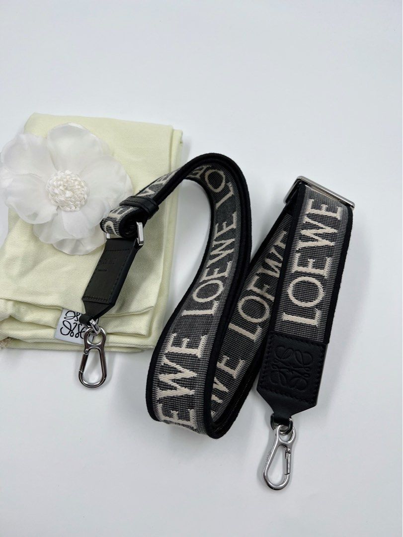 ⚜️Loewe Reversible Strap (Category: Luxury Accessories) located in Makati City. Submitted by 90sangel (Listing ID 1308214442, Image 1). Description: •Item: Loewe - White Anagram-jacquard Reversible Shoulder Strap 🖤 •Size: One size •Condition: Excellent! 💯 *W/ Adjustable fit carabiner attachments. This piece comes complete with a protective dust bag / paperbag. Material:calfskin/Fabric. 🖤🤍.