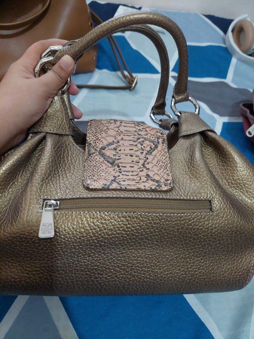 Nicole Miller Preloved bag (Category: Shoulder Bags) located in Galimuyod. Submitted by royalforest.76e82f (Listing ID 1393124906, Image 2). Description: Nicole Miller Preloved bag Snake skin leather design. Not sure if real snake skin. Good condition. Metal hardwares are shiny. Location: Ilocos Sur.