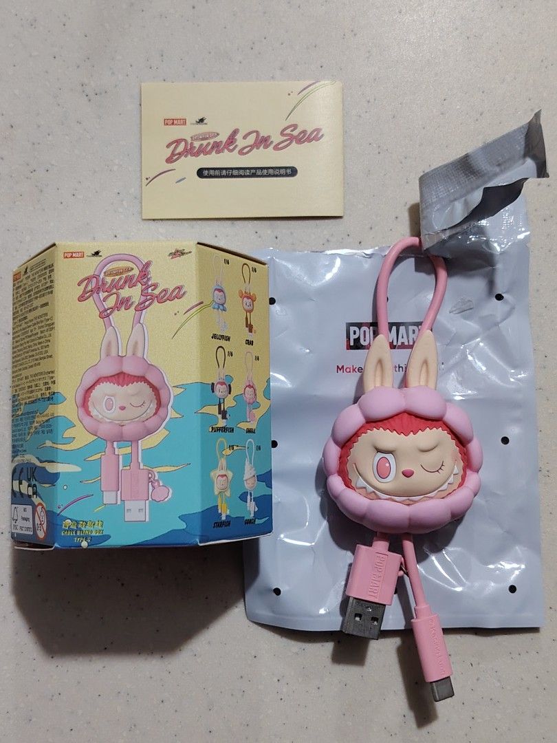 Pop Mart Drunk in Sea type C Cable pendant (Category: Designer & Blind Box Toys) located in Quezon City. Submitted by sureandlegit (Listing ID 1393093116, Image 3). Description: For sale 100 % Aunthentic Pop Mart item The Monsters Drunk in Sea Cable Pendant Shell design Comes complete with opened box bottom part, unsealed foil just to check if it is working then return to box. What you see what you get Pls be mindful before making an offer, be re