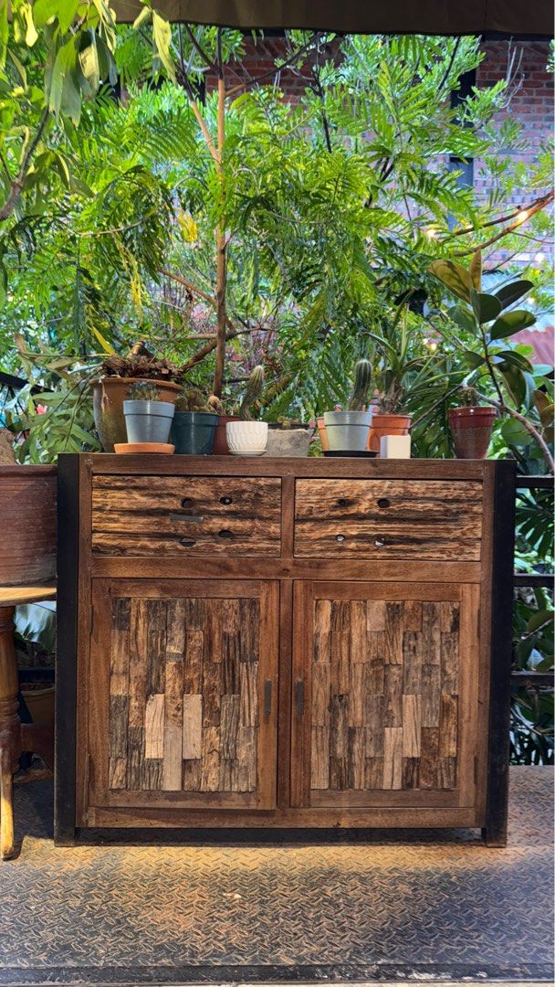 SOLID TEAKWOOD CABINET RUSTIC PATCHWORK DESIGN (Category: Tables & Sets) located in Cheras. Submitted by sfeaa95 (Listing ID 1393086459, Image 1). Description: Unique solid teakwood cabinet with natural patchwork textures, combining character and durability. Featuring two spacious drawers and double door storage, this piece is both functional and stylish. Perfect for living, dining, or café display. RM2,100 Delivery can be arranged. .