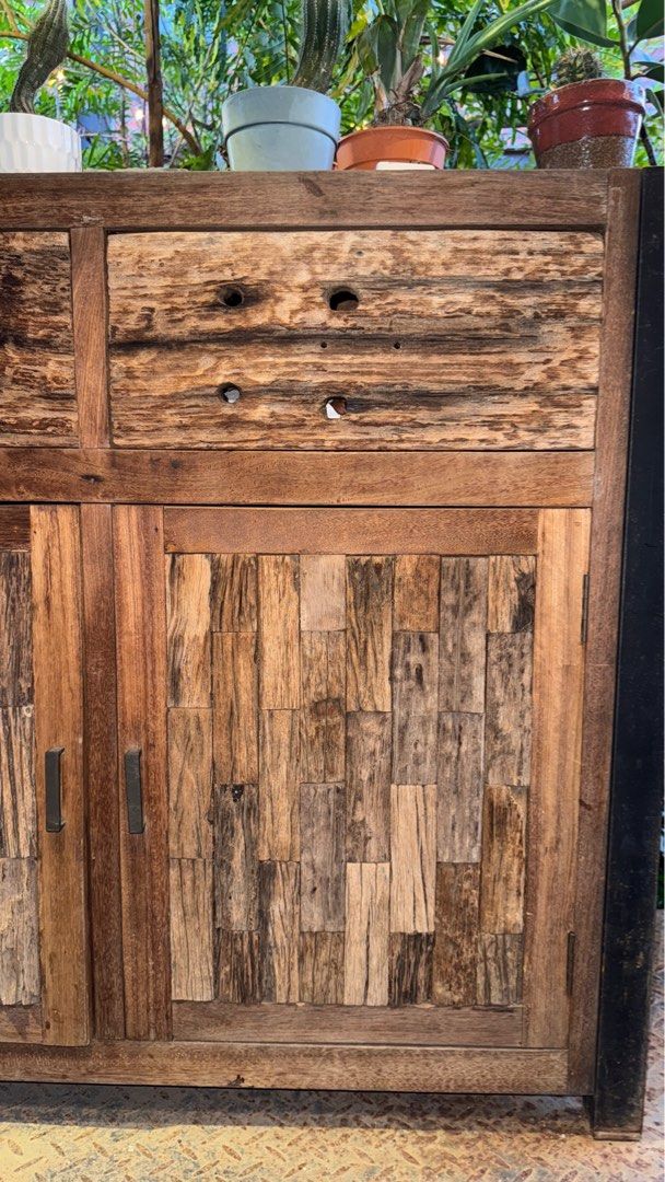 SOLID TEAKWOOD CABINET RUSTIC PATCHWORK DESIGN (Category: Tables & Sets) located in Cheras. Submitted by sfeaa95 (Listing ID 1393086459, Image 2). Description: Unique solid teakwood cabinet with natural patchwork textures, combining character and durability. Featuring two spacious drawers and double door storage, this piece is both functional and stylish. Perfect for living, dining, or café display. RM2,100 Delivery can be arranged. .
