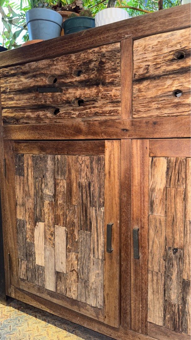 SOLID TEAKWOOD CABINET RUSTIC PATCHWORK DESIGN (Category: Tables & Sets) located in Cheras. Submitted by sfeaa95 (Listing ID 1393086459, Image 3). Description: Unique solid teakwood cabinet with natural patchwork textures, combining character and durability. Featuring two spacious drawers and double door storage, this piece is both functional and stylish. Perfect for living, dining, or café display. RM2,100 Delivery can be arranged. .