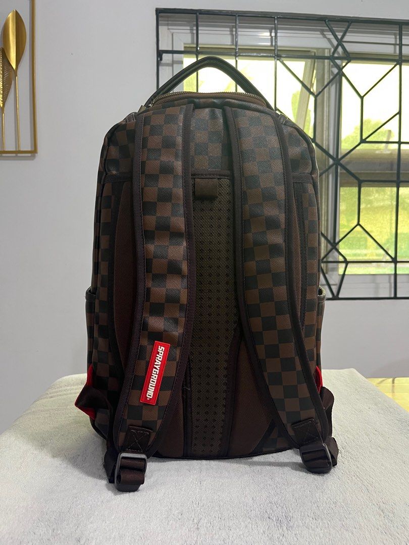 Sprayground Shark in Paris (brown) backpack (Category: Backpacks) located in Cabanatuan. Submitted by leonard0897 (Listing ID 1393187489, Image 3). Description: Selling preloved Sprayground Shark in Paris (brown) backpack PRODUCT DETAILS Exterior Dimensions: 18” x 6” x 11.5” • Front zipper pocket • Side pockets • Zippered Stash pocket • Separate velour sunglass compartment • Ergonomic mesh back padding • Adjustable Straps for custom sizing • Gold