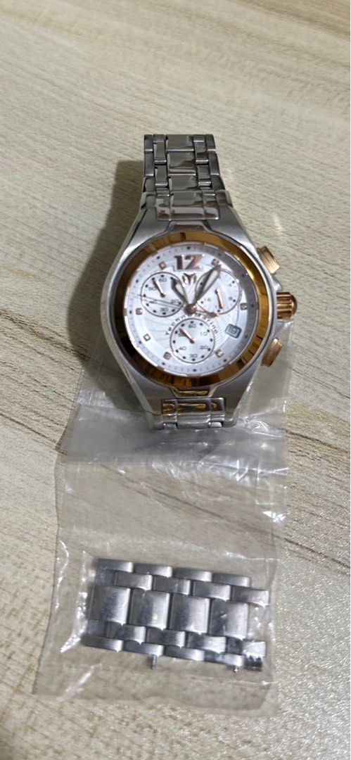 Authentic Technomarine Mantaray (Category: Luxury Watches) located in Malabon City. Submitted by vintagemom (Listing ID 1393339978, Image 1). Description: Stainless steel case with a two-tone (silver and gold-plated) stainless steel bracelet. Fixed gold-plated bezel. Silver dial with luminous gold-tone hands and crystal hour markers. An Arabic numeral appears at the 12 o’clock position. Minute markers around the outer rim. Dial Type: Analog. Lumi