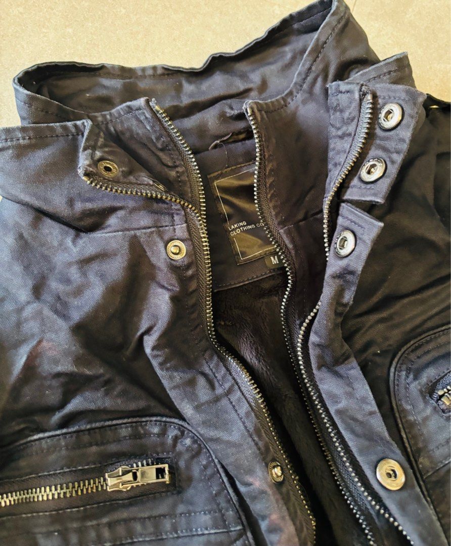 Jacket (Category: Coats, Jackets and Outerwear) located in Singapore. Submitted by koris_box (Listing ID 1393319567, Image 4). Description: Visibly well worn. Wrinkled and creased due to keeping in storage. With fleeced lining except on the sleeves. 2 sets of zips, and 1 row of buttons. Top pockets are fake pockets. 2 working side pockets with zips. Bought in Taiwan, brand is Laking. Please note that this is a WELL WORN jacket. .