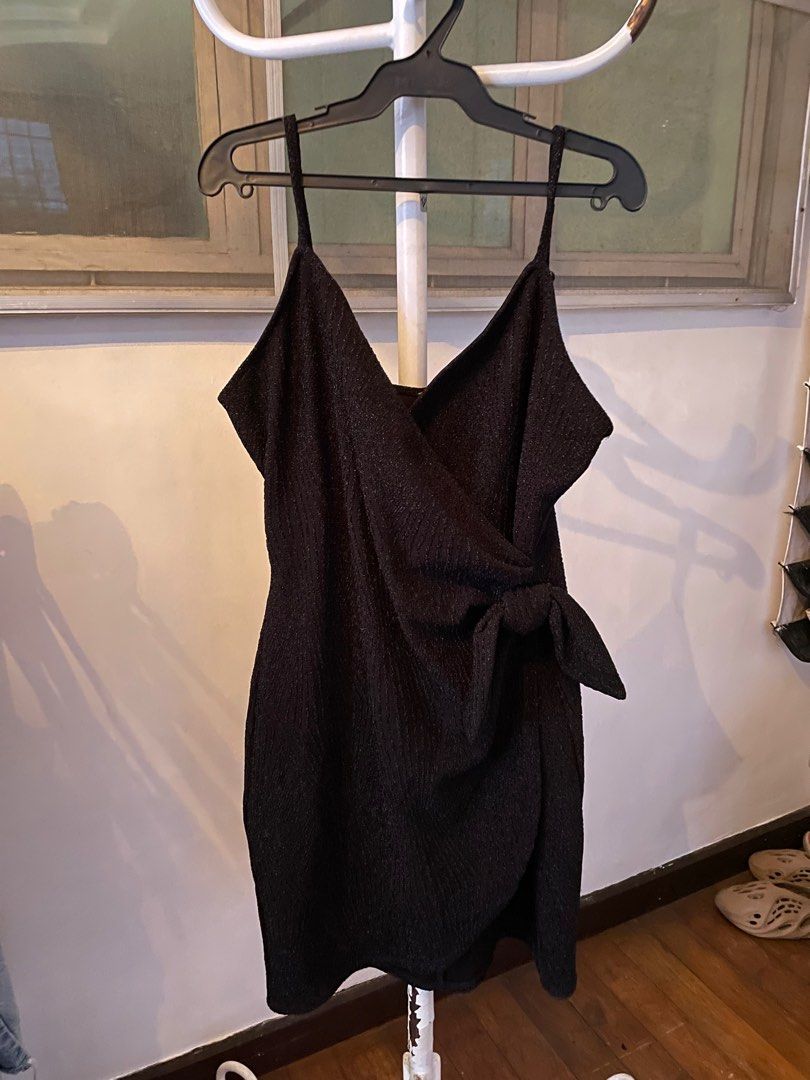 Black Glittery Wrap Mini Dress with Side Bow (Category: Evening dresses & gowns) located in Manila. Submitted by azishops (Listing ID 1393545518, Image 1). Description: Size: large (but fits medium frames) Color: black Rfs: decluttering Pay as you order Mop: gcash/maya Shipping: lalamove (same day), j&t delivery once a week, shouldered by buyer.