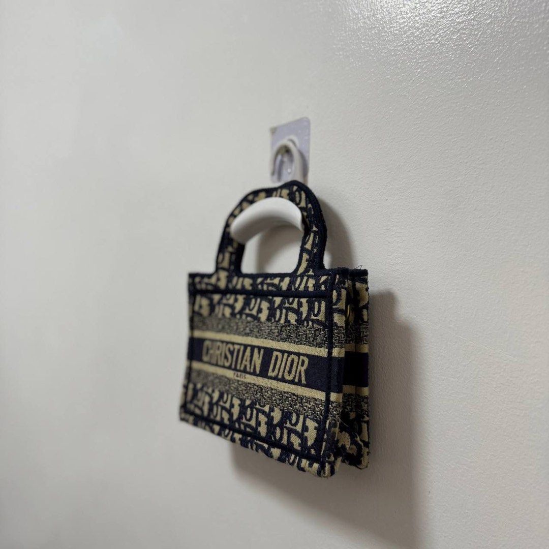Mini Dior Book Tote Bag (Category: Luxury Bags & Wallets) located in Manila. Submitted by retro.archives (Listing ID 1393598908, Image 3). Description: Mini Dior Book Tote Bag 📌 Width: 9" Height: 6" Depth: 1.5" Handle: 10" Condition: 9/10 Issue: Missing Sling 🧷 Price: 1500 + sf 📍 Angeles City, Pampanga 🚛 Courier – J&T (Regular Shipping) .