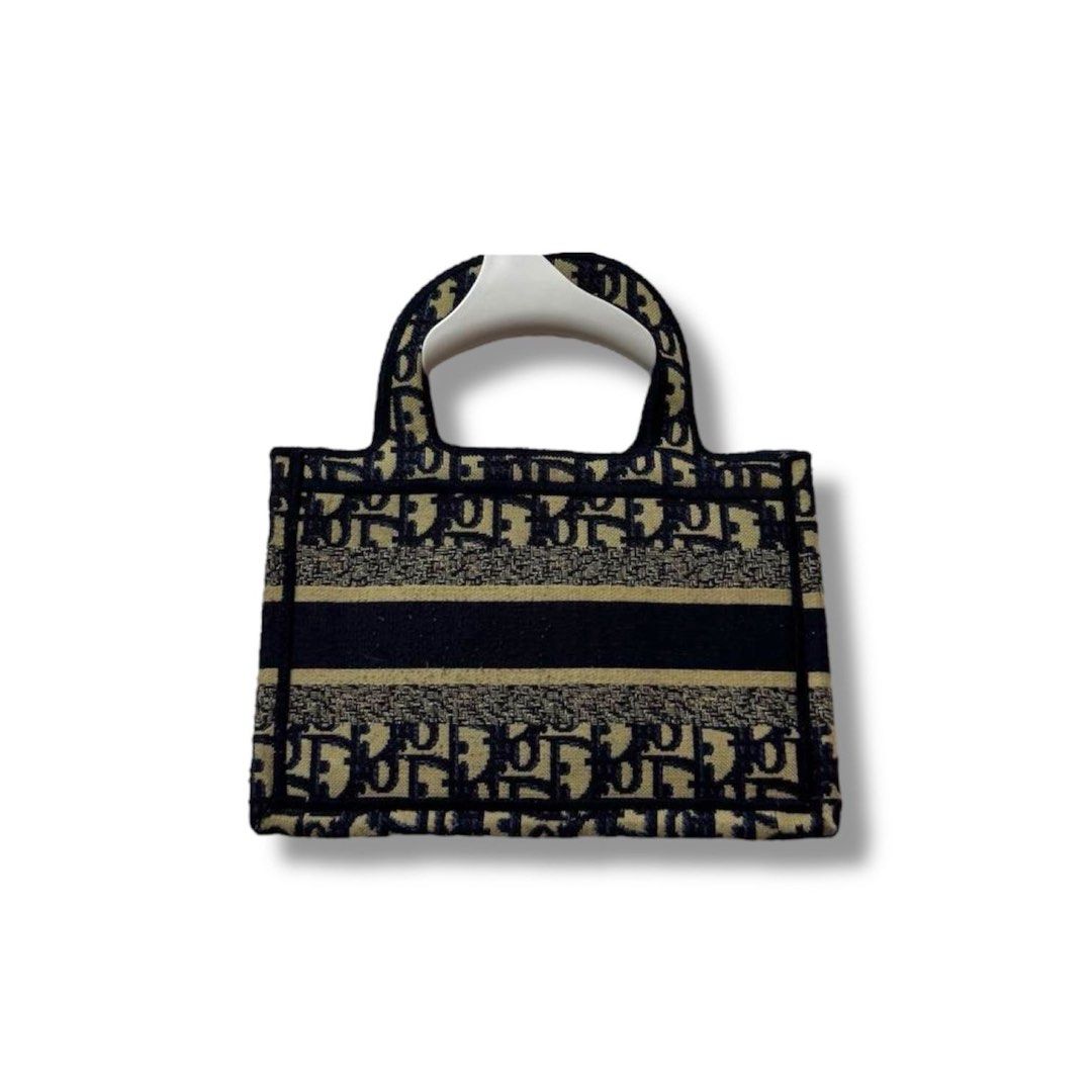 Mini Dior Book Tote Bag (Category: Luxury Bags & Wallets) located in Manila. Submitted by retro.archives (Listing ID 1393598908, Image 2). Description: Mini Dior Book Tote Bag 📌 Width: 9" Height: 6" Depth: 1.5" Handle: 10" Condition: 9/10 Issue: Missing Sling 🧷 Price: 1500 + sf 📍 Angeles City, Pampanga 🚛 Courier – J&T (Regular Shipping) .