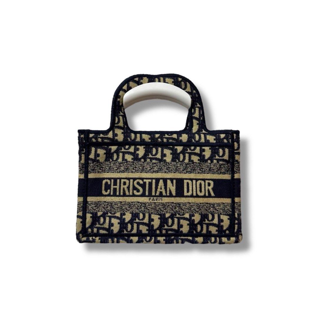 Mini Dior Book Tote Bag (Category: Luxury Bags & Wallets) located in Manila. Submitted by retro.archives (Listing ID 1393598908, Image 1). Description: Mini Dior Book Tote Bag 📌 Width: 9" Height: 6" Depth: 1.5" Handle: 10" Condition: 9/10 Issue: Missing Sling 🧷 Price: 1500 + sf 📍 Angeles City, Pampanga 🚛 Courier – J&T (Regular Shipping) .