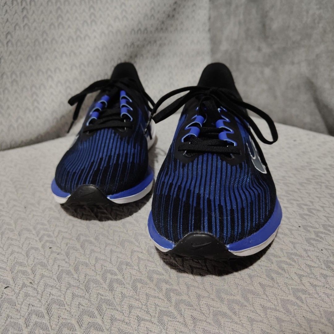 Nike Zoom Air Running Shoes Blue Black (Category: Sneakers) located in Manila. Submitted by james101194 (Listing ID 1393456098, Image 2). Description: Nike Zoom Air running shoes in blue and black. Features a blue and black striped upper with a white sole. The shoes have black laces and a Nike swoosh logo on the side. The size is US 8, UK 7, EUR 41, and CM 26. The style code is DD6203-004..