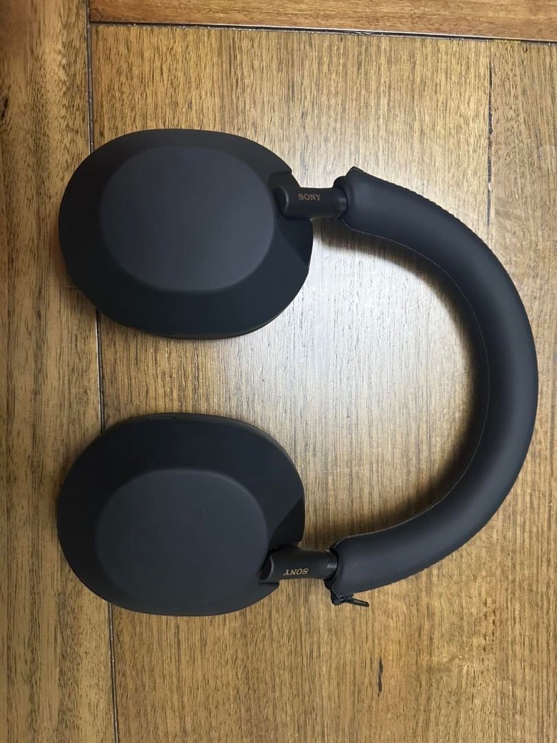 WH-1000XM5 (Category: Headphones & Headsets) located in Taguig. Submitted by lengarcia73 (Listing ID 1393575030, Image 3). Description: Sony WH-1000XM5. Rarely used since bluetooth earphones were more convenient. Slight defect on the hinge as shown on the photos above. Hinge is not broken, protective layer is loose but can be pushed back in. Silicone case and headband cover is included, Wicked Cushions is also installed instead of the original pa