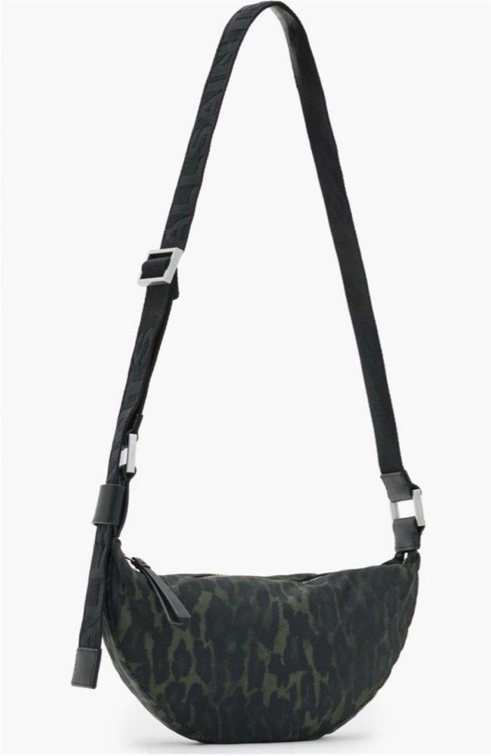 ALL SAINTS Half Moon Crossbody Bag (Category: Cross-body Bags) located in Makati City. Submitted by pick_en_click (Listing ID 1390408440, Image 1). Description: ALL SAINTS Half Moon Crossbody Bag A logo-patterned strap adds a signature flourish to a crescent-shaped crossbody bag patterned in a bold leopard print. • Cotton lining • Textile with leather trim • Leopard Green in color • 4”W x 5 1/2”H x 1 1/2”D (Interior capacity: extra-small.) • 4” -