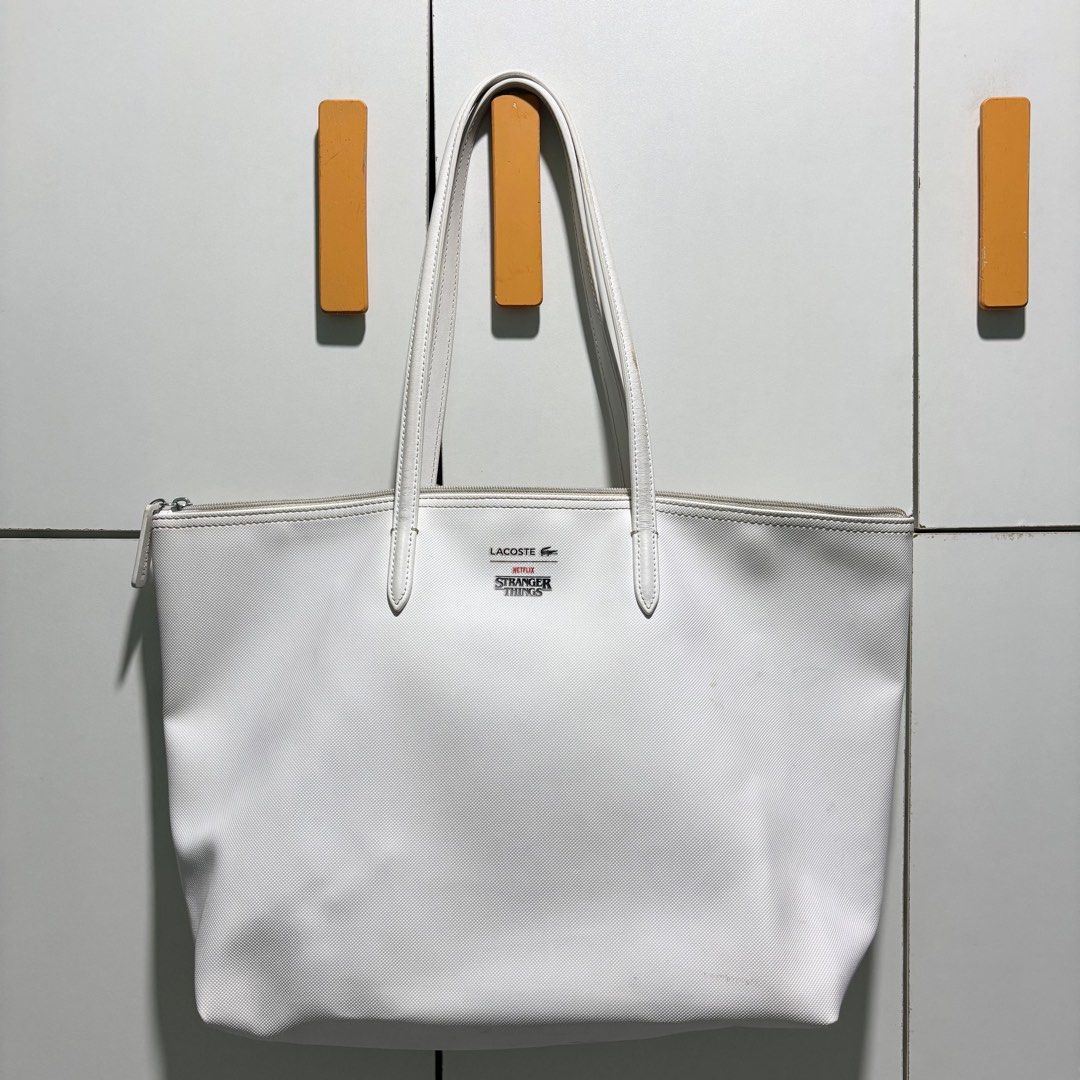 (AUTHENTIC 💯) Lacoste x Stranger Things Large Shoulder/Tote Bag (Category: Shoulder Bags) located in Manila. Submitted by codeofethixx (Listing ID 1390293294, Image 2). Description: ➡️ Used. No damage but may signs of usage. ❕Out of stock na to sa stores MOP: GCash, GoTyme & Seabank 📗 STRICTLY PAYMENT FIRST BEFORE SHIP OUT, i’ll accommodate request po to assure you of a legitimate transaction..