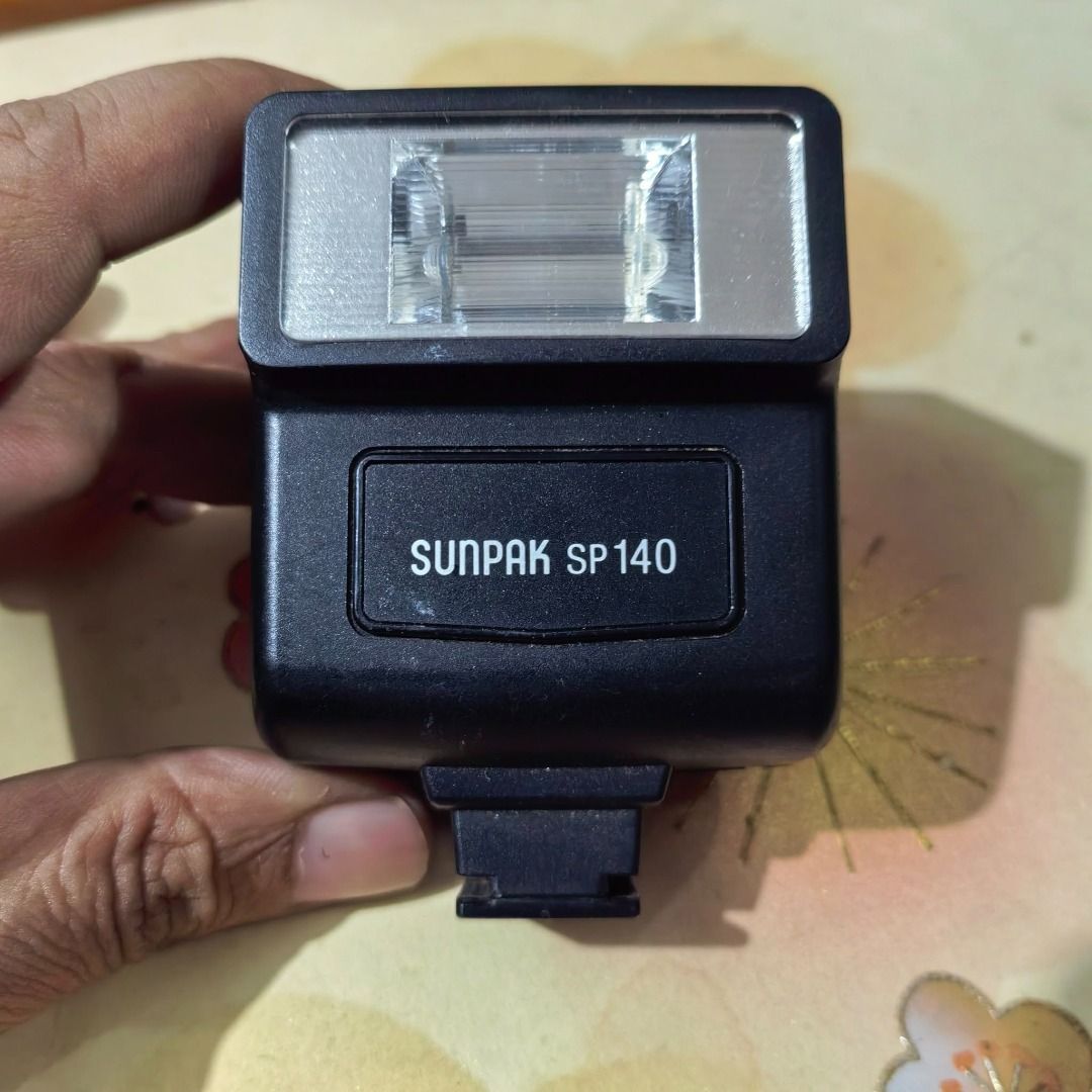 Camera Flash Unit Brand: Sunpack SP140 (Category: Flashes) located in Cebu City. Submitted by dudes_villanueva (Listing ID 1390268185, Image 3). Description: Camera Flash Unit Brand: Sunpack SP140 Condition: Untested‼️‼️‼️ Sold as is. 📌This is a vintage, shoe-mount flash designed for film cameras, particularly compatible with models like the Olympus Trip 35, RD, RC, and SP. 📌It operates using two AA batteries. 📌The flash unit features both a h