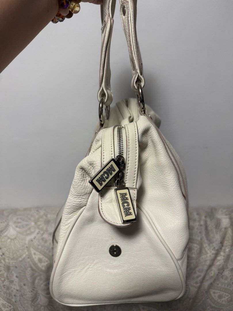 Handbag (Category: Luxury Bags & Wallets) located in Taguig. Submitted by shoppersgalore.ph (Listing ID 1393813510, Image 3). Description: Selling my Original Preloved MCM Ivory Patent Leather Studded Motifs Large Shoulder/Hand Bag. Used but nit abused only signed of usage mga Sis ginagamit kolang kapag may mga events ako not more than 10 times mga Sis. RFS: Decluttering and since after my operation in my right arm not allowed to used a heavy bag