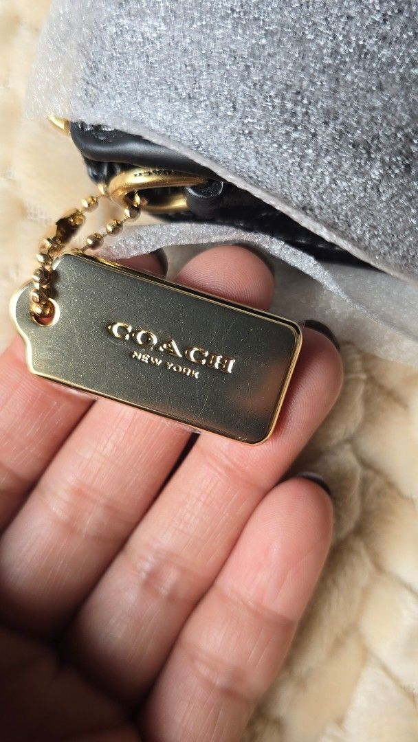 Coach Noa Sling Wallet (Category: Luxury Bags & Wallets) located in Taguig. Submitted by the.seekers.ph (Listing ID 1393783647, Image 2). Description: - Authentic Coach crossbody bag - Color: Black - Detachable strap - Closure: Zip and snap - Includes Coach hangtag and card - Interior tag: 'Philippines'.