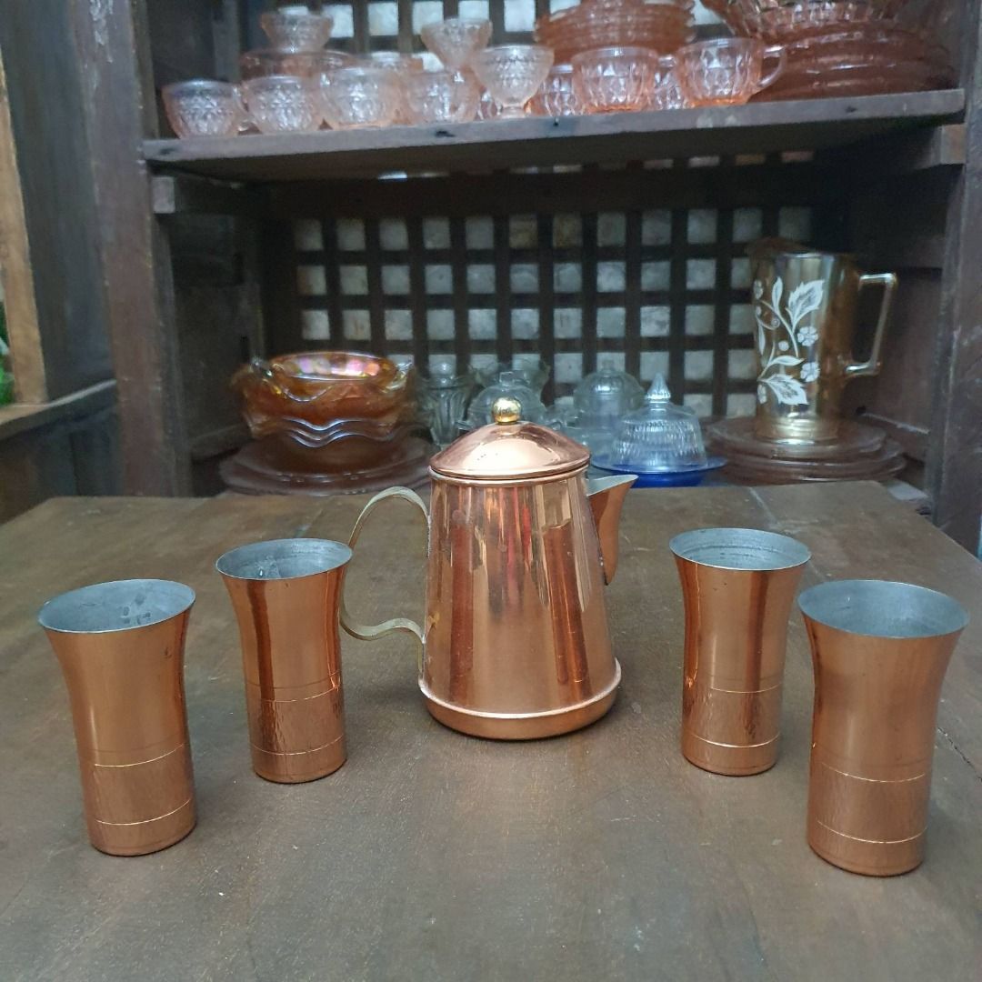 Copper tea set (Category: Coffee & Tea Tableware) located in Pasig City. Submitted by fine.finds (Listing ID 1393751845, Image 1). Description: Soft glow and antique warmth radiate from this vintage copper tea set — a charming ensemble with one kettle and four matching glasses, thoughtfully crafted to serve tea with timeless elegance. The hammered copper texture and classic silhouette reflect traditional metalwork styles from mid‑20th century cra