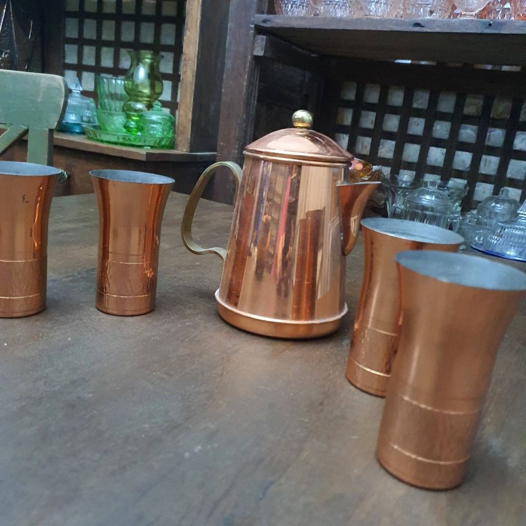 Copper tea set (Category: Coffee & Tea Tableware) located in Pasig City. Submitted by fine.finds (Listing ID 1393751845, Image 3). Description: Soft glow and antique warmth radiate from this vintage copper tea set — a charming ensemble with one kettle and four matching glasses, thoughtfully crafted to serve tea with timeless elegance. The hammered copper texture and classic silhouette reflect traditional metalwork styles from mid‑20th century cra