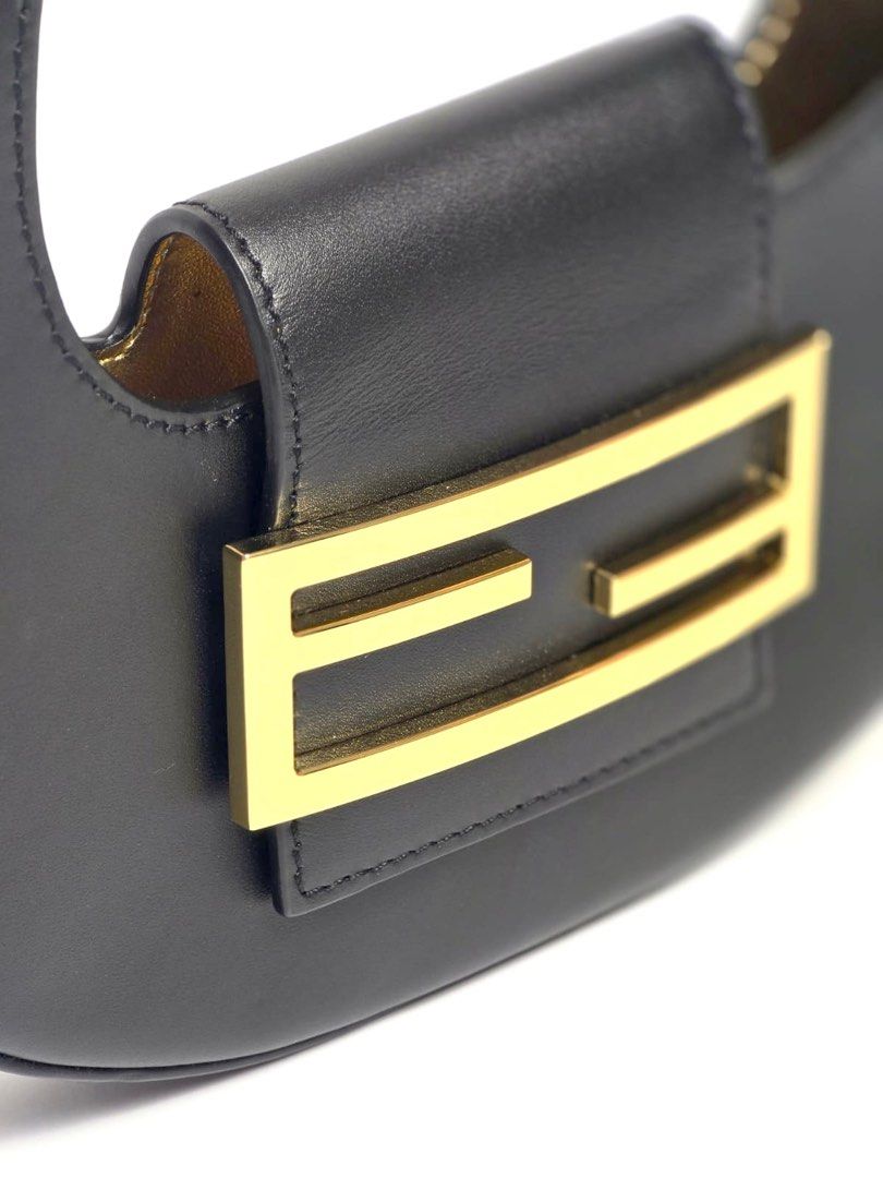 Fendi Black Mini Cookie Hobo Bag (Category: Luxury Bags & Wallets) located in Pandi. Submitted by luximperium (Listing ID 1393623964, Image 3). Description: Color: Black Includes: Dust bag Material: Calfskin Leather Size: Small Dimensions: L (21cm), H (12.5cm), W (2.6cm), HD (20cm—adjustable) Closure & Pockets: Flap closure with magnetic snap Hardware: Gold-tone Condition: Pristine Others: Lining and under strap feature gold leather detail.