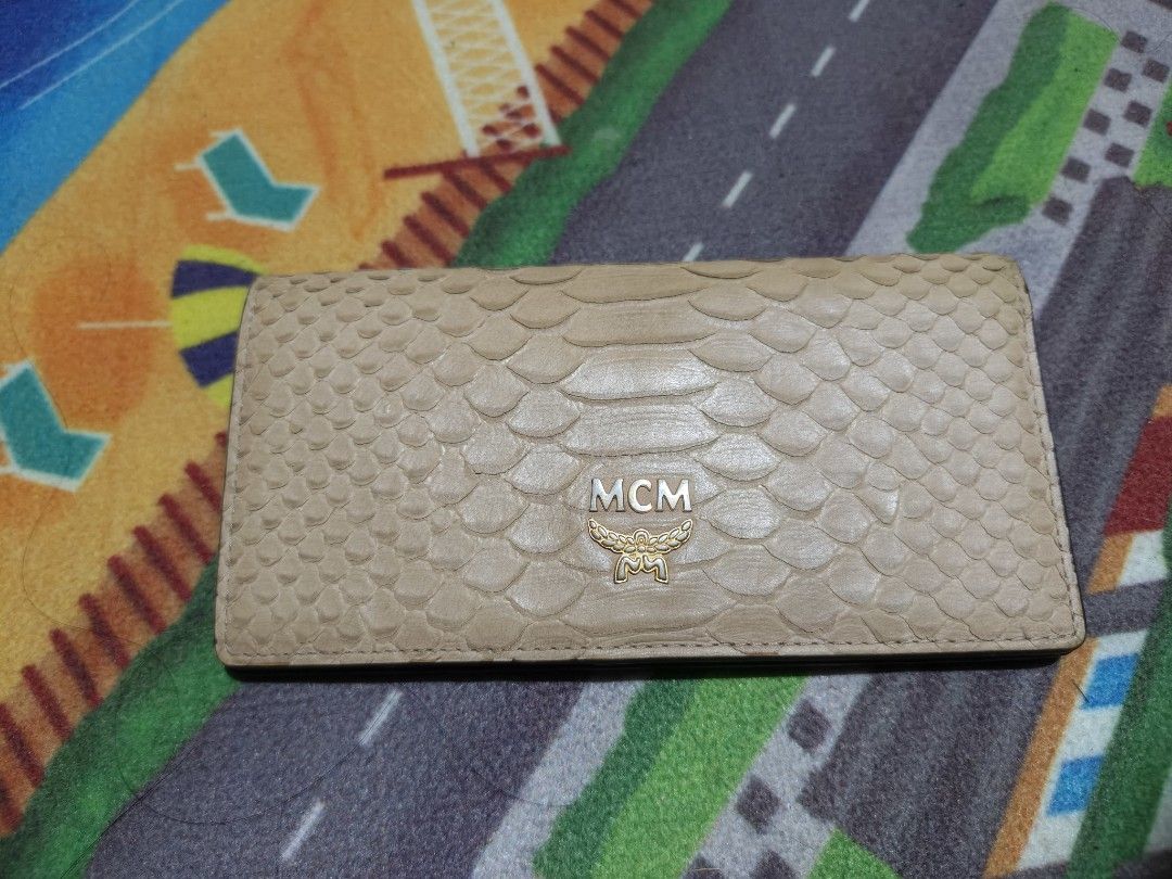 MCM Snake Skin Wallet (Category: Luxury Bags & Wallets) located in Camalaniugan. Submitted by thrifter10 (Listing ID 1393736698, Image 2). Description: Authentic MCM wallet with snake skin design. Features card slots, ID window, and zippered compartment. Snap closure with MCM logo. Made in Korea. Issue.. slightly Fade on leather , it was shown on the picture.