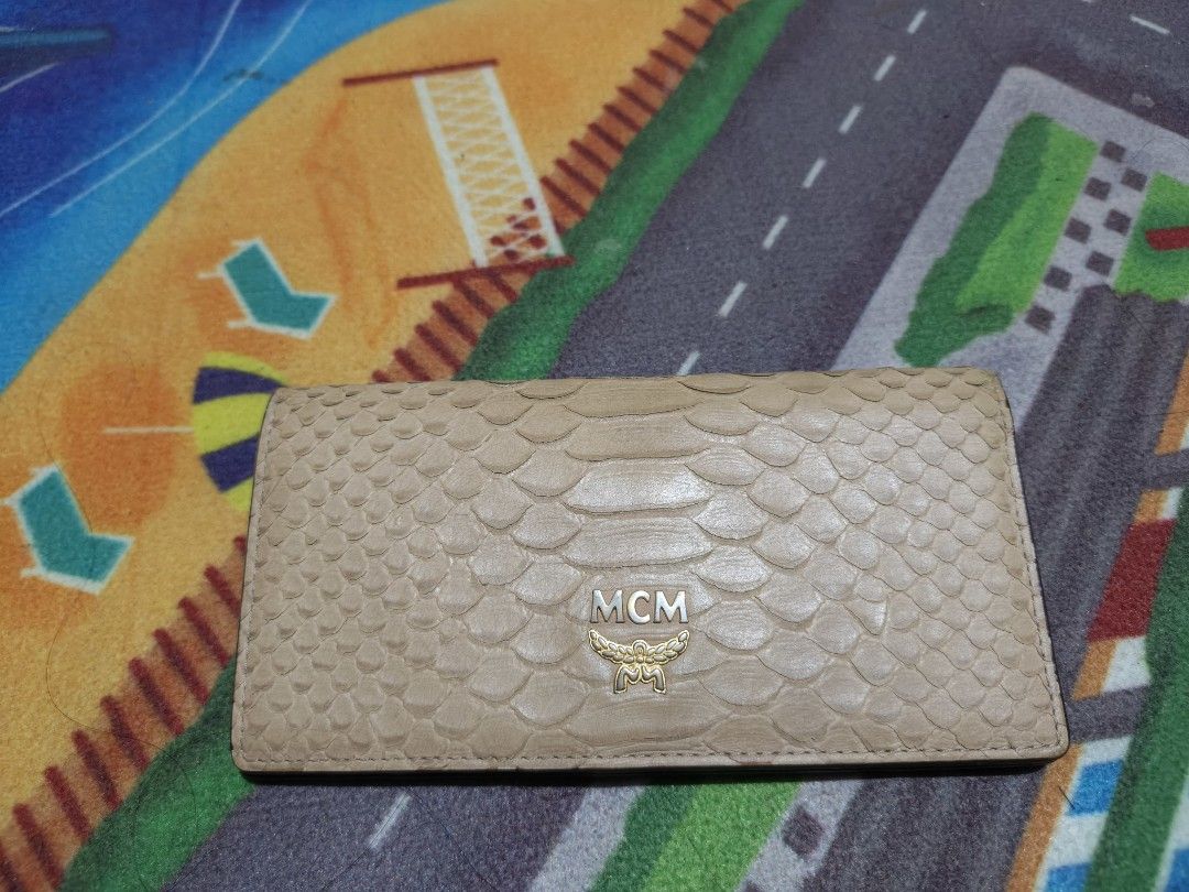 MCM Snake Skin Wallet (Category: Luxury Bags & Wallets) located in Camalaniugan. Submitted by thrifter10 (Listing ID 1393736698, Image 3). Description: Authentic MCM wallet with snake skin design. Features card slots, ID window, and zippered compartment. Snap closure with MCM logo. Made in Korea. Issue.. slightly Fade on leather , it was shown on the picture.