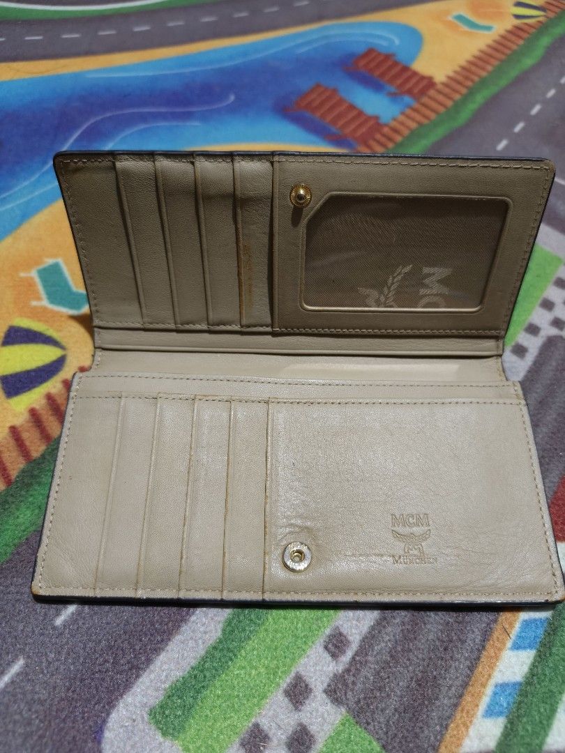 MCM Snake Skin Wallet (Category: Luxury Bags & Wallets) located in Camalaniugan. Submitted by thrifter10 (Listing ID 1393736698, Image 1). Description: Authentic MCM wallet with snake skin design. Features card slots, ID window, and zippered compartment. Snap closure with MCM logo. Made in Korea. Issue.. slightly Fade on leather , it was shown on the picture.