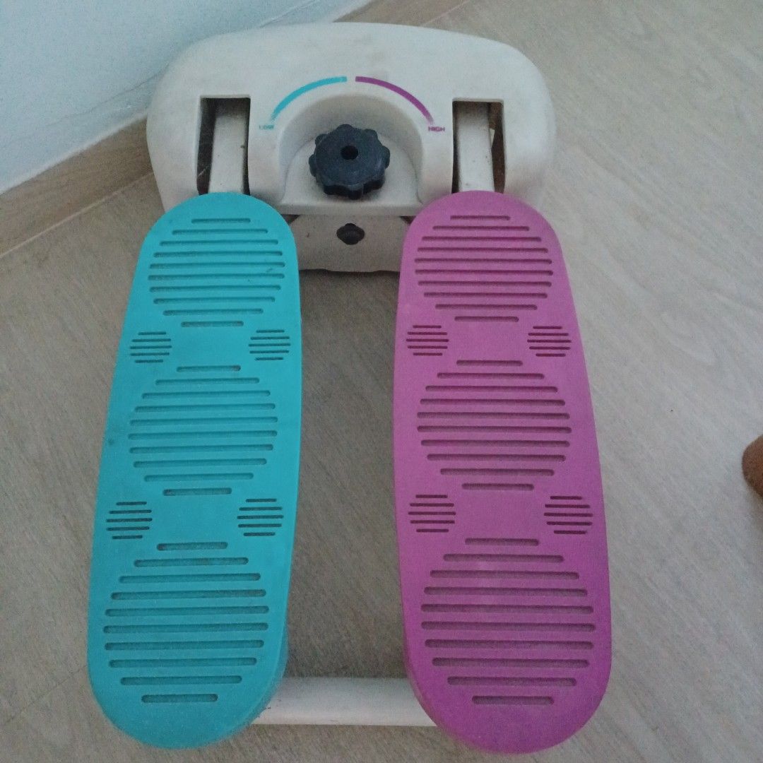 Mini Stepper Exercise Machine (Category: Cardio & Fitness Machines) located in Singapore. Submitted by easy_dragon (Listing ID 1393661769, Image 1). Description: - Compact mini stepper for home use. - Adjustable resistance. - Features pink and blue foot pads. - Good working condition. - Perfect for cardio and leg exercises. - Shows some signs of wear and tear..
