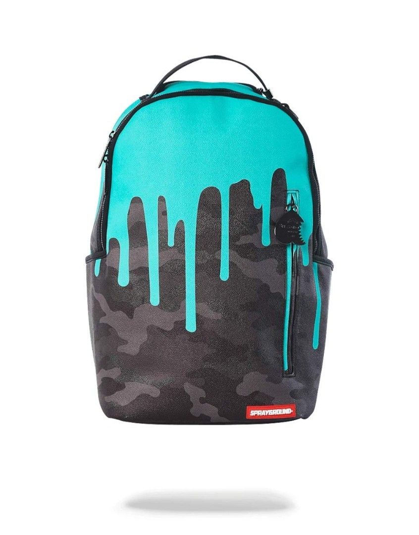 Sprayground Drip Camo Backpack (Category: Backpacks) located in Manila. Submitted by renzmalacc07450 (Listing ID 1393621571, Image 2). Description: Sprayground Tiff Drip Camo Teal Leather bought in middle east leather may mga issue na kit naman s pic baliwag bulacan 1800 - Sprayground backpack with unique drip camo design. - Teal top with black drips over a camouflage pattern. - Features multiple zippered compartments and side pockets. - Includes