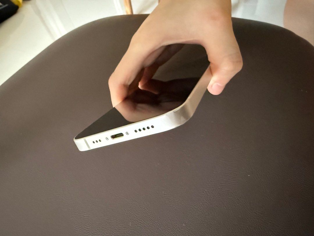 (Category: iPhone 13 Series ) located in Singapore. Submitted by blueblewbrew (Listing ID 1393973636, Image 2). Description: - iPhone 13 (White) - Battery Health: 83% - Fully functional - Includes charging port.