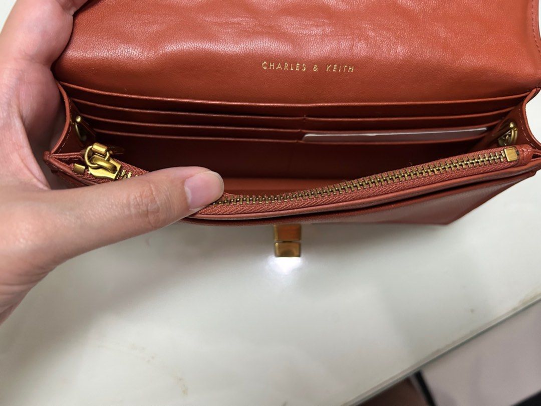 Charles&Keith Quilted Long Wallet Bag (Category: Luxury Bags & Wallets) located in Manila. Submitted by sammyyy19 (Listing ID 1393913527, Image 3). Description: Charles & Keith Quilted Long Wallet With Gold Hardware With minor wear and tear at lock but not super visible (see photo) No discoloration No rusting of chain strap No peeling of leather No scratches Condition: 8/10.