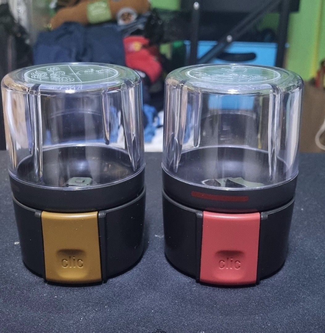 Clic Spice Grinder - Gold and Red (Category: Coffee & Tea Tableware) located in Manila. Submitted by ags028705 (Listing ID 1393827668, Image 1). Description: - Set of two Clic spice grinders - One grinder with a gold base - One grinder with a red base - Clear plastic tops - Black body - 'Clic' logo visible - spares - COD.