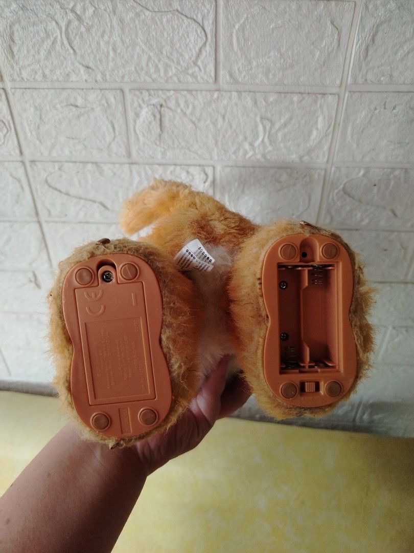 Orange Cat Plush Toy Furreal (Category: Plushies & Soft Toys) located in Tayasan. Submitted by _raceprettyconcept (Listing ID 1393821820, Image 3). Description: - Adorable orange cat plush toy - Comes with a sweet pink bow - Features a soft white chest and paws - Includes a battery compartment ( walang takip ang isang bat compartment) (batteries not included).