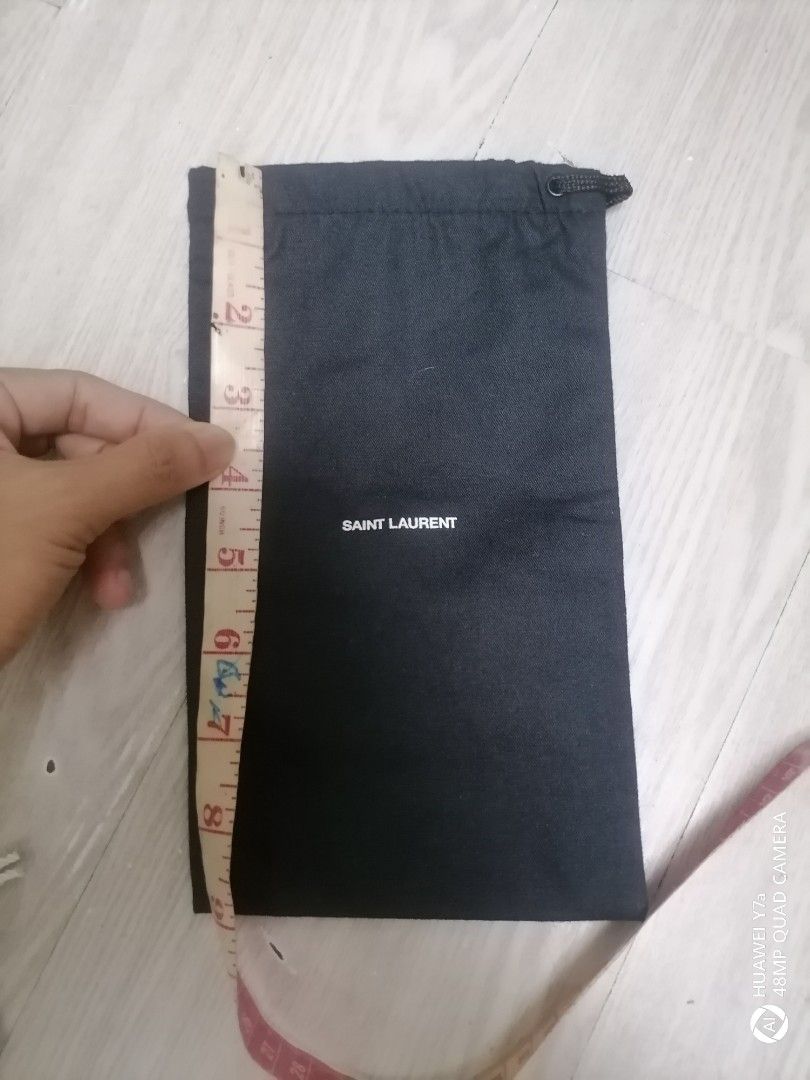 Saint Laurent Dust Bag (Category: Luxury Bags & Wallets) located in Naga. Submitted by mrwisethrifter (Listing ID 1393919495, Image 1). Description: - Authentic Saint Laurent dust bag - Black color - Features the Saint Laurent logo - Drawstring closure - White interior - Made in Italy - Dimensions: Approximately 10 inches x 7 inches.
