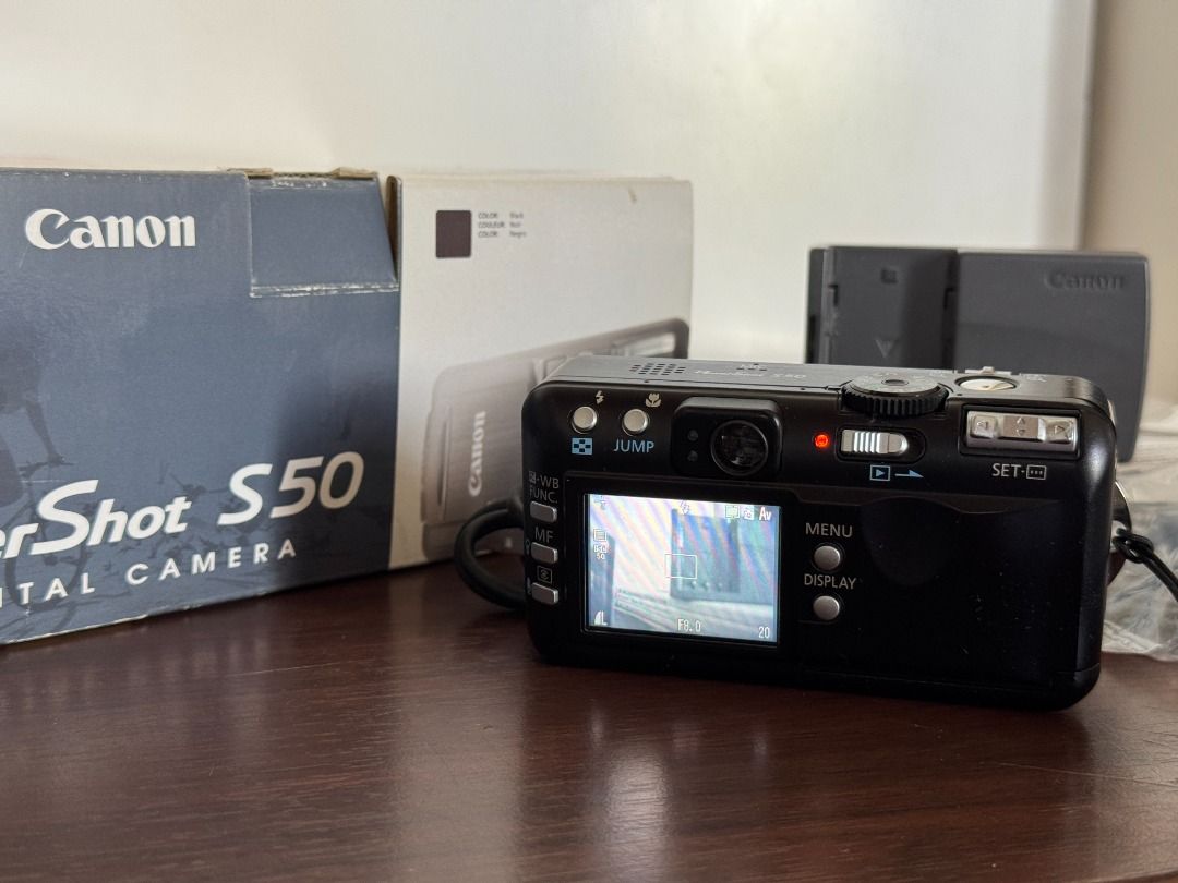Vintage Canon PowerShot S50 (Category: Cameras) located in Quezon City. Submitted by niwdr0 (Listing ID 1393838206, Image 2). Description: Selling my personal camera Early 2000's Canon PowerShot S50 for Php. 5,700 **GDrive link for samples: https://drive.google.com/drive/folders/1tT_F88xNgd6Z7lW3rGB5-0fZZwu4L7l8?usp=sharing Condition: 9.5/10 almost mint condition. Minor scratches on the frame (see pictures) Issues: None Inclusions: • Unit • 2x Ca