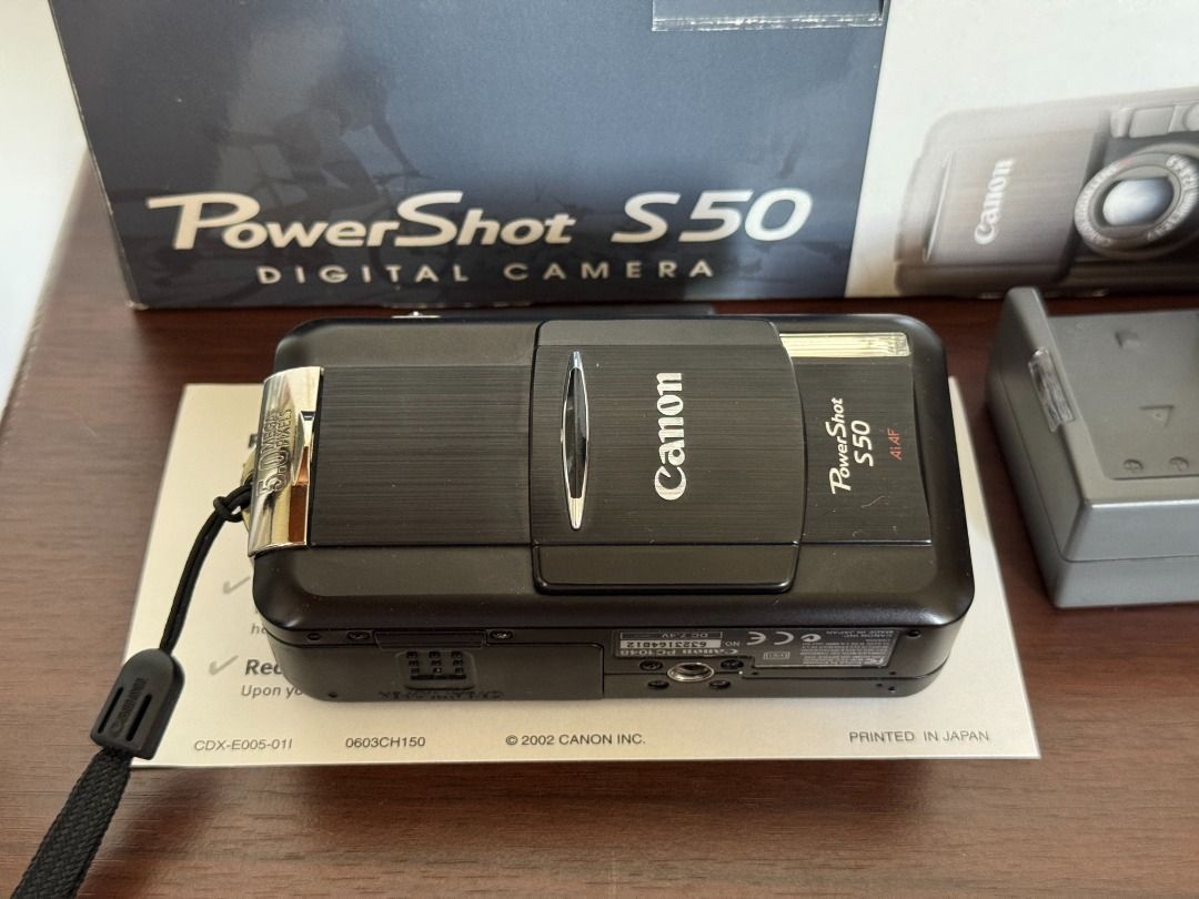 Vintage Canon PowerShot S50 (Category: Cameras) located in Quezon City. Submitted by niwdr0 (Listing ID 1393838206, Image 3). Description: Selling my personal camera Early 2000's Canon PowerShot S50 for Php. 5,700 **GDrive link for samples: https://drive.google.com/drive/folders/1tT_F88xNgd6Z7lW3rGB5-0fZZwu4L7l8?usp=sharing Condition: 9.5/10 almost mint condition. Minor scratches on the frame (see pictures) Issues: None Inclusions: • Unit • 2x Ca